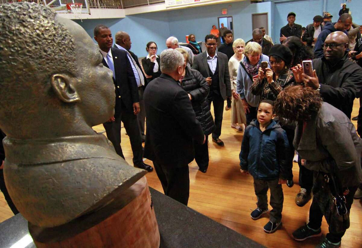 Xavier Best, 5, of Waterbury, gazes up at a bust of the Rev. Dr. Martin Luther King Jr. after it was unveiled during a ceremony at the Ansonia Armory Wednesday, on the 50th anniversary of King’s assassination. The bust was created by Ansonia resident Vasil Rakaj. See story, B1