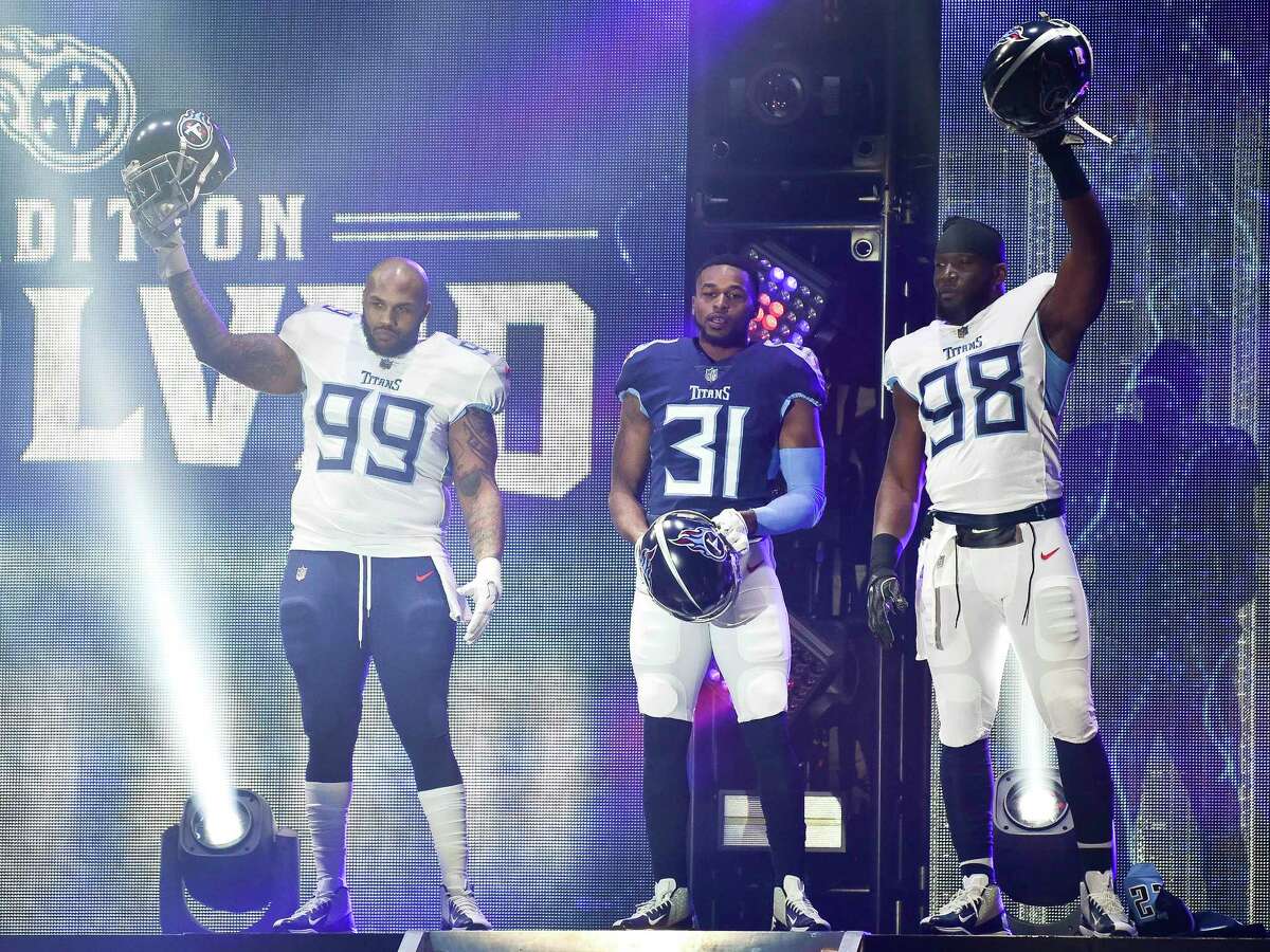 Tennessee Titans defensive tackle Jurrell Casey (99), safety Kevin Byard (31) and linebacker Brian Orakpo (98) show off new uniforms as the NFL football team revealed the redesigned uniforms, in Nashville, Tenn., Wednesday, April 4, 2018. (Andrew Nelles/The Tennessean via AP)