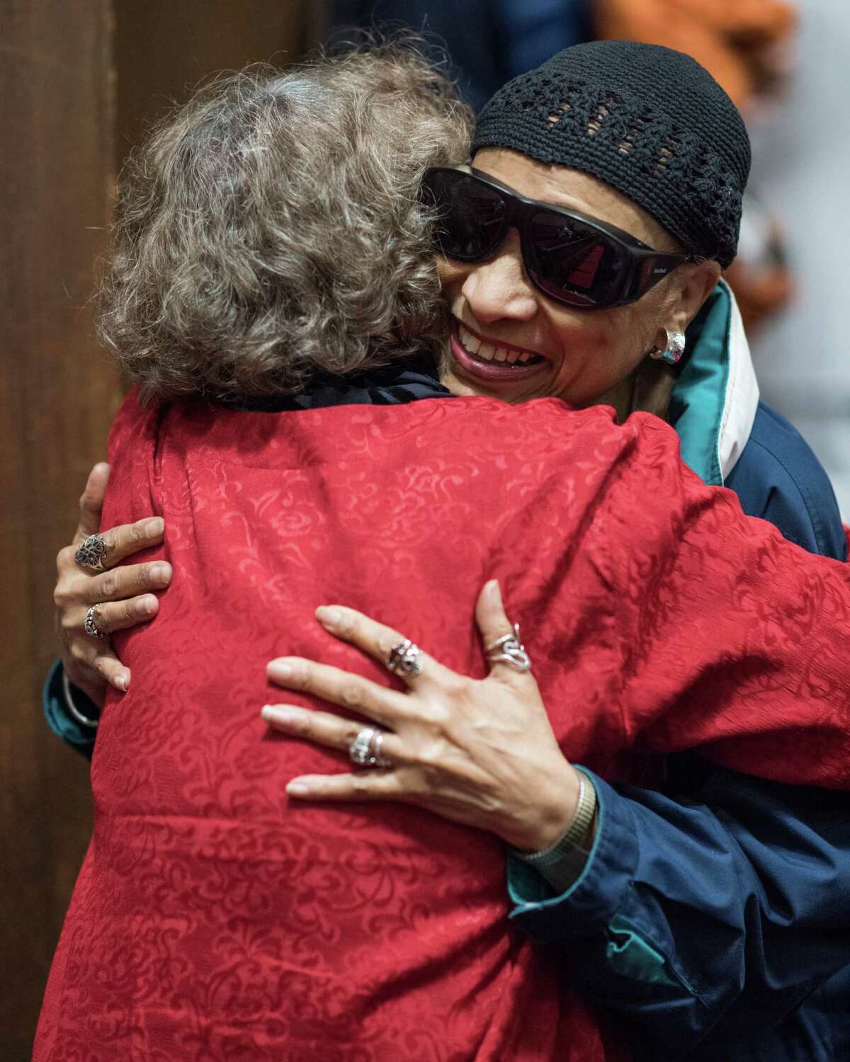 A member of the Total Experience Choir hugs Rev. Pat Wright before a ceremony remembering and honoring the legacy of Rev. Dr. Martin Luther King Jr. at Mount Zion Baptist Church in Seattle.