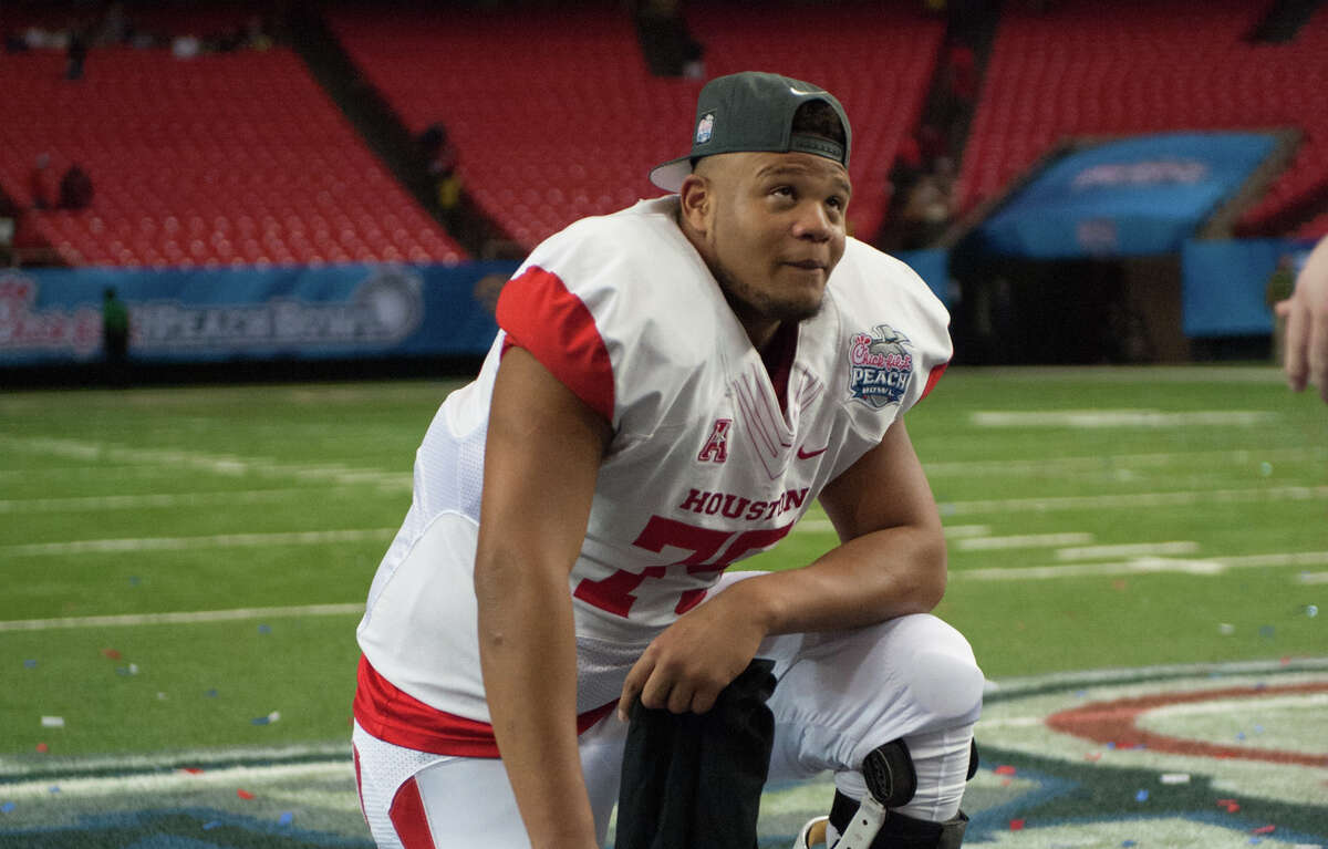 31 December 2015: Houston Cougars offensive lineman Marcus Oliver (75) takes a moment to reflect after a hard faught victory in the 2015 Chick-Fil-A Peach Bowl between the Florida State Seminoles and the Houston Cougars at the Georgia Dome in Atlanta, Georgia. (Photo by John Adams/Icon Sportswire) (Photo by John Adams/Icon Sportswire/Corbis via Getty Images)