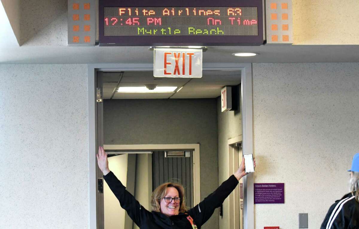 Passengers celebrate being the first to take Elite Airways' non-stop flight to Myrtle Beach from Albany International Airport on Thursday, April 5, 2018, in Colonie, N.Y. The airline offers twice-weekly flights on Thursday and Sunday. (Will Waldron/Times Union)