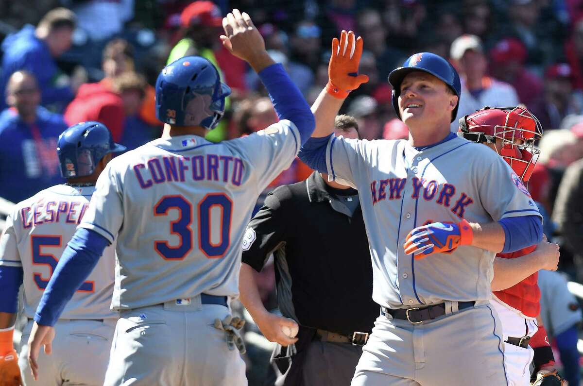 WASHINGTON, DC - APRIL 05: Jay Bruce #19 of the New York Mets celebrates with Michael Conforto #30 after hitting a grand slam in the seventh inning against the Washington Nationals during the home opener at Nationals Park on April 5, 2018 in Washington, DC. New York won the game 8-2.