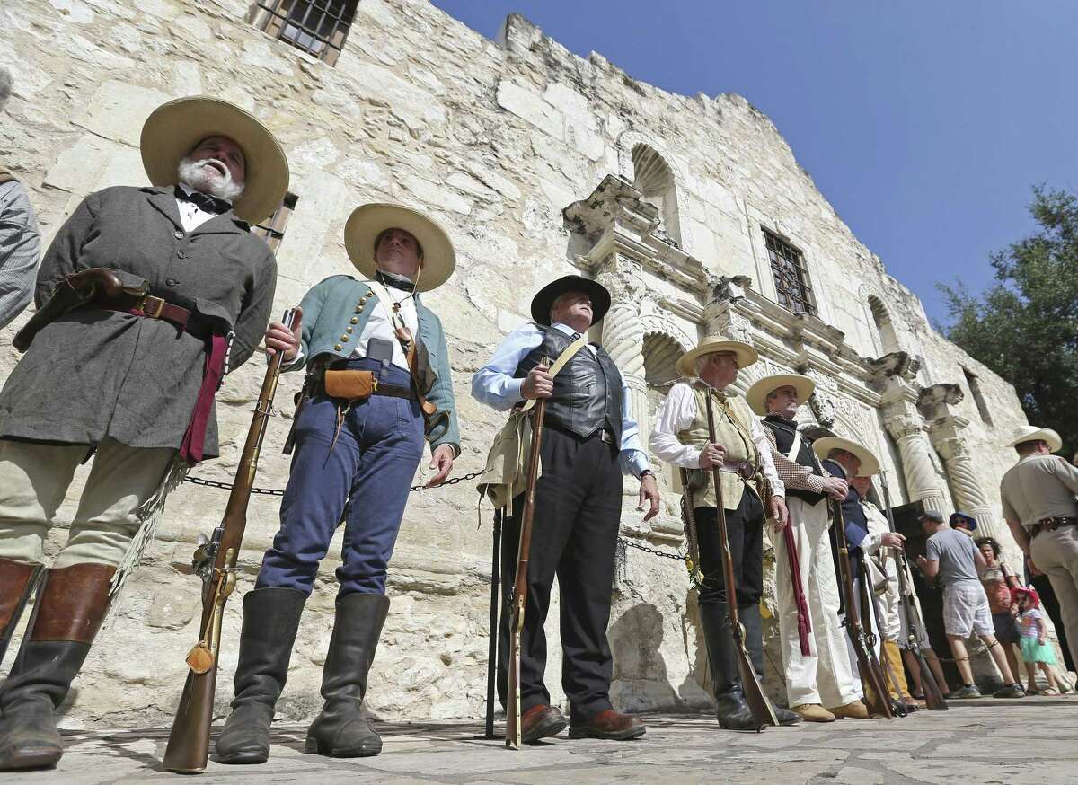 Members of The Texas Army take part in a ceremony ending the Daughters of the Republic of Texas' 110-year custodianship of the Alamo Friday July 10, 2015.