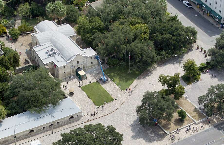 Alamo Plaza, with the Alamo at the top of the frame, is seen in a 2015 aerial photo.  A local Native American has filed a legal notice declaring it to be on an abandoned or unknown cemetery, a move that could delay the $450 million project to restore and enhance the sacred Texas shrine. Photo: WILLIAM LUTHER,  Staff / San Antonio Express-News / © 2015 San Antonio Express-News