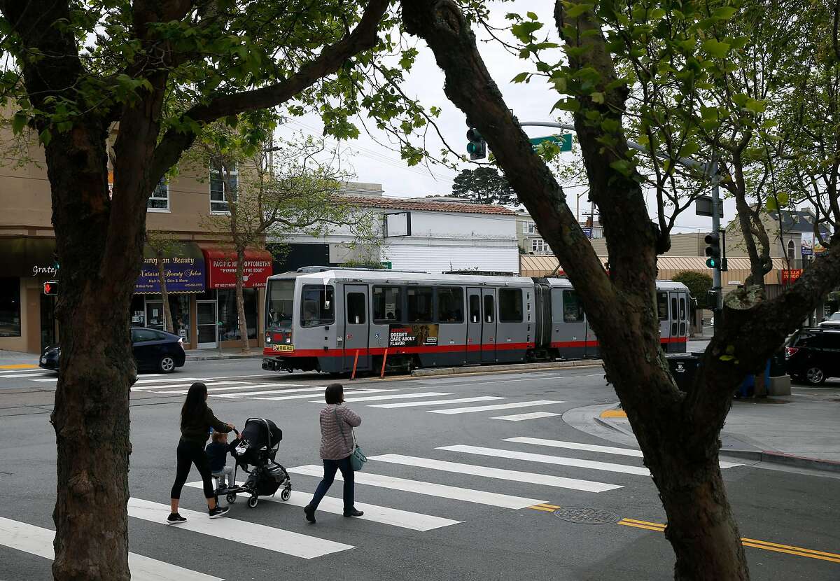 Two women cross Vicente Street on West Portal Avenue in San Francisco, Calif. on Thursday, April 5, 2018. Supervisor and mayoral candidate Jane Kim is opposing SB827, authored by state Sen. Scott Wiener, which would require cities to allow four- to eight-story apartment and condo buildings in residential areas if they are within a half mile of major transit hubs and would also mandate that cities allow such buildings within a quarter mile of highly used bus and light-rail stops.