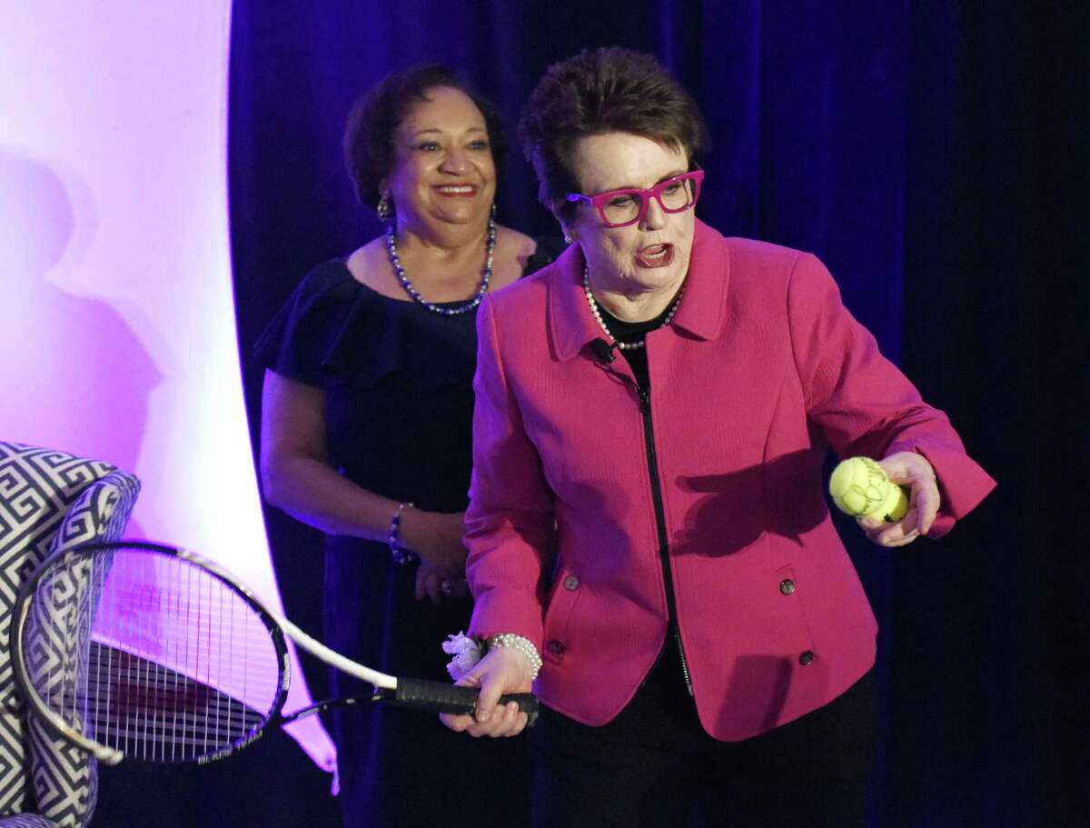 Tennis legend Billie Jean King hits tennis balls into the crowd beside County's Community President and CEO Juanita James after speaking at the “Courage to Create Change” annual luncheon at the Hyatt Regency.