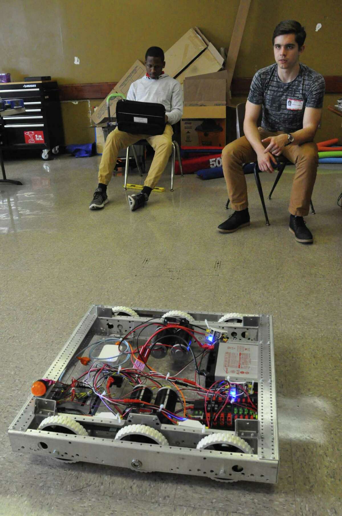 Rashard Randall, a member of the Yates High School robotics team and Rice University mentor Cannon Lewis watch as their entry in the FIRST Robotics competition maneuvers in their classroom. This is the first year that a team from Yates High School has built a robot for the FIRST Robotics competition. The FIRST World Championship at the George R. Brown Convention Center from April 15-18, which is free and open to the public.