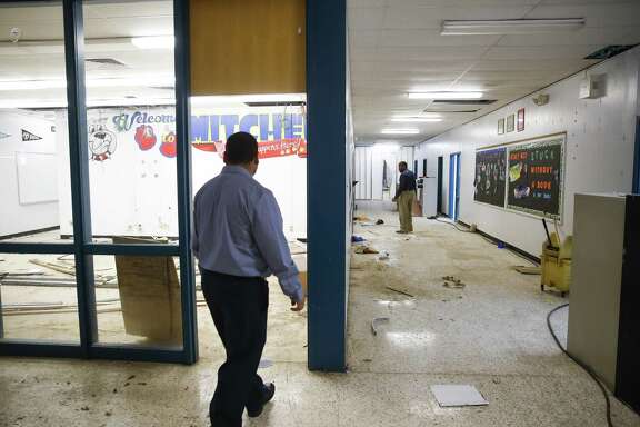 HISD security maintenance manager Rick Villanueva, left, and HISD Bond senior construction manager Sizwe Lewis, right, tour Mitchell Elementary Thursday, Dec. 14, 2017 in Houston. The school was flooded with about two feet of water during Hurricane Harvey. ( Michael Ciaglo / Houston Chronicle)