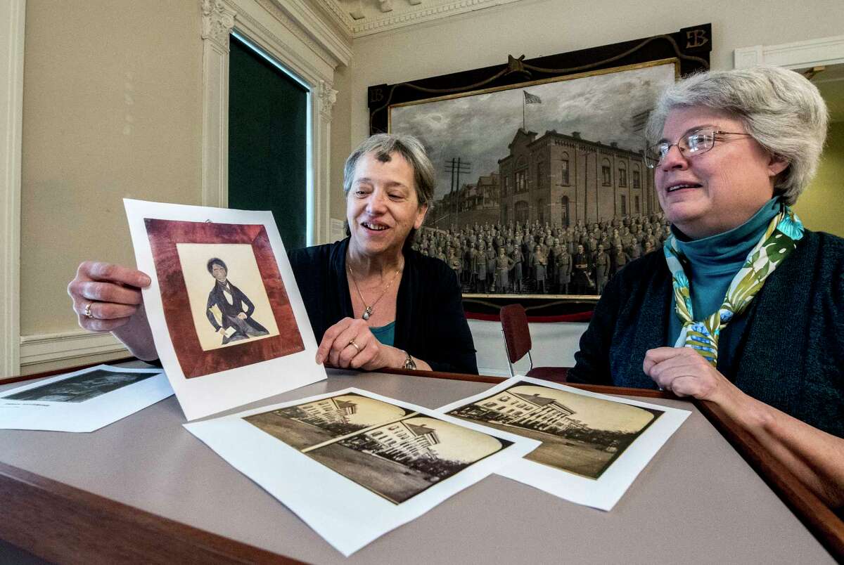 Rensselaer County and Troy City Historian Kathy Sheehan, left, and Stacy Pomeroy Draper, curator, look over a photo of the artwork they are trying to purchase of Peter F. Baltimore, father of Garnet Douglass Baltimore, first African American graduate of RPI and city engineer on Wednesday Feb. 14, 2018, in Troy, N.Y. (Skip Dickstein/Times Union) Wednesday Feb. 14, 2018 at the Rensselaer County Historical Society in Troy, N.Y. (Skip Dickstein/Times Union)