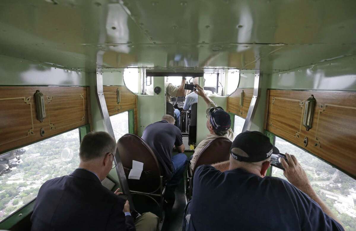Passengers look out during a flight on the Experimental Aircraft Association's 1929 Ford Tri-Motor Thursday, April 5, 2018, in Houston. The EAA is selling tickets to the public for short flights at West Houston Airport from Thursday through Sunday. From 1926 through 1933, Ford Motor Company built 199 Tri-Motors. The EAA’s model 4-AT-E was the 146th off Ford’s innovative assembly line and first flew on August 21, 1929. It was sold to Pitcairn Aviation’s passenger division, Eastern Air Transport, whose paint scheme is replicated on EAA’s Tri-Motor. ( Melissa Phillip / Houston Chronicle )