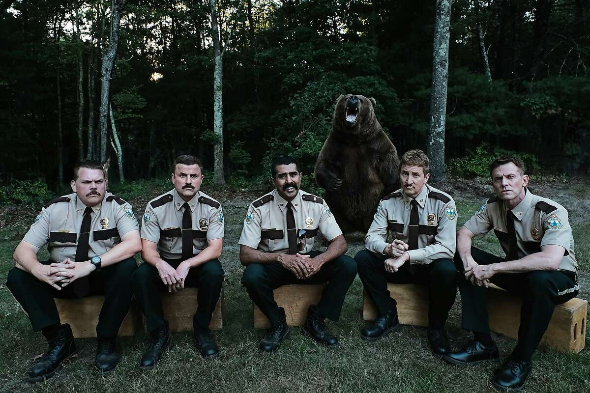 A still from "Super Troopers 2": L-R: Writers and stars Kevin Heffernan, Steve Lemme, Jay Chandrasekhar, Paul Soter, and Erik Stolhanske, with a furry co-star.