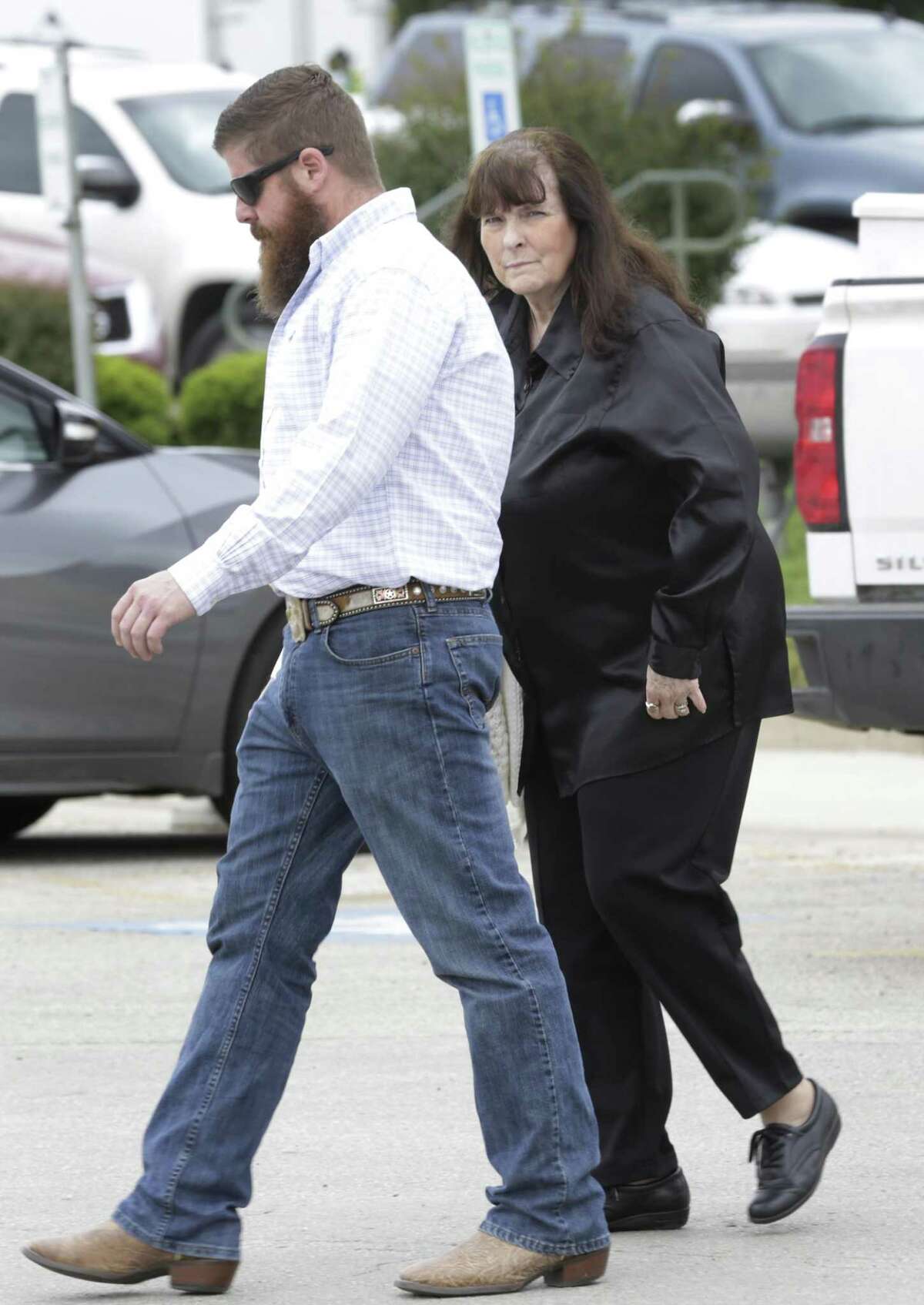 Yvonne Whitney, right, mother of SAPD Officer Robert Deckard who was killed by Shaun Puente, walks with a relative near the Atascosa Courthouse in Jourdanton, where the jury in the trial of Puente, was stuck and the judge decided on life in prison without parole, held on Friday, April 6, 2018.