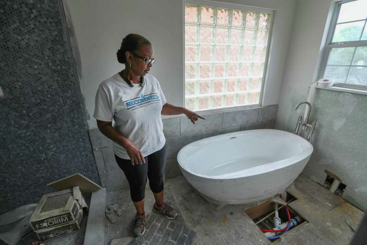 Carolyn Brown looks at her bathroom that is not completed, Thursday, April 5, 2018, in Houston. Her husband, Tyrone, is being treated for cancer, are now relying on tens of thousands of dollars in low-interest loans to repair their home that was destroyed by Hurricane Harvey. ( Steve Gonzales / Houston Chronicle )