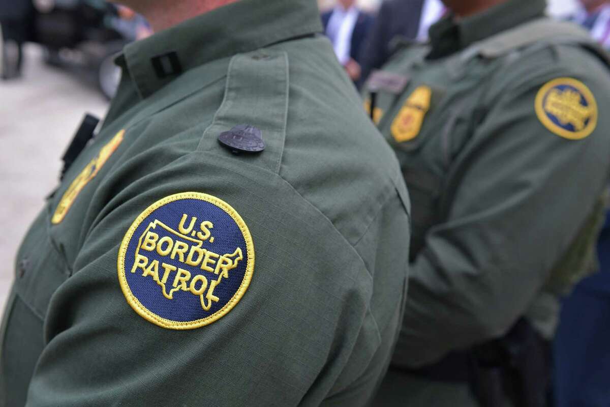 Members of the US Border Patrol listen as US President Donald Trump speaks after inspecting border wall prototypes in San Diego, California on March 13, 2018. / AFP PHOTO / MANDEL NGANMANDEL NGAN/AFP/Getty Images