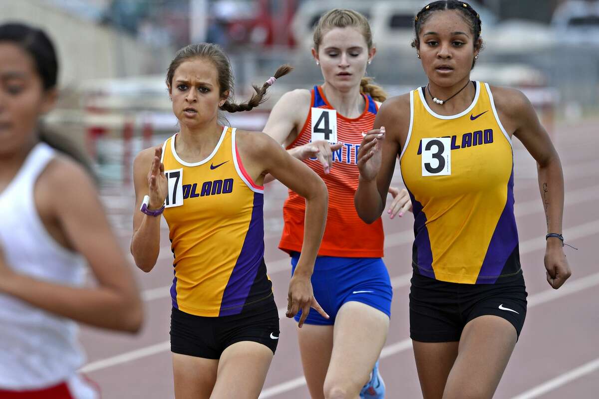 Midland High juniors Kandus Box, left, and Jenia Mitchell, right, compete in the girls 800 meter race during the District 2-6A track meet April 6, 2018, at Memorial Stadium. James Durbin/Reporter-Telegram