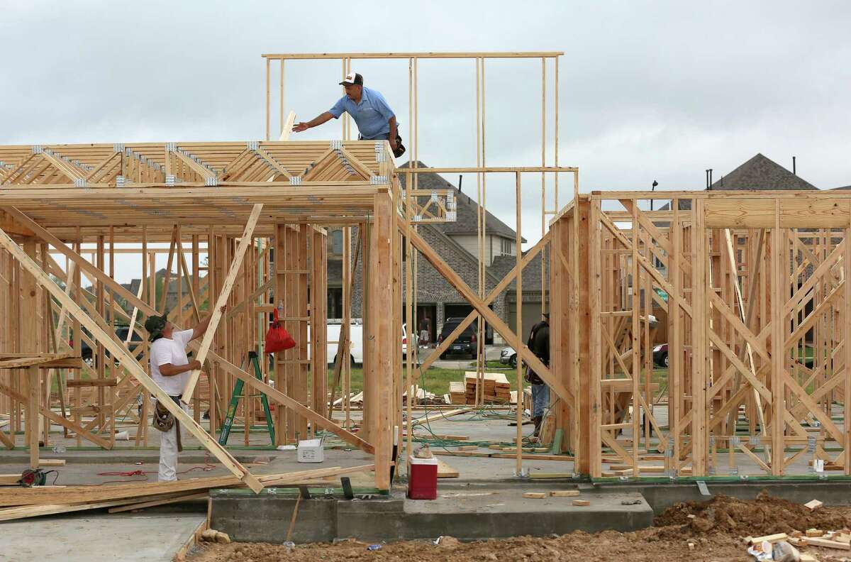 A construction crew works on a new home at Elyson, a new master-planned community in the northwest Harris County, Friday, April 6, 2018, in Katy, Texas. The developer of Elyson was undaunted by the risks posed by three flood plains that traverse the 3,600-acre property. ( Godofredo A. Vasquez / Houston Chronicle )