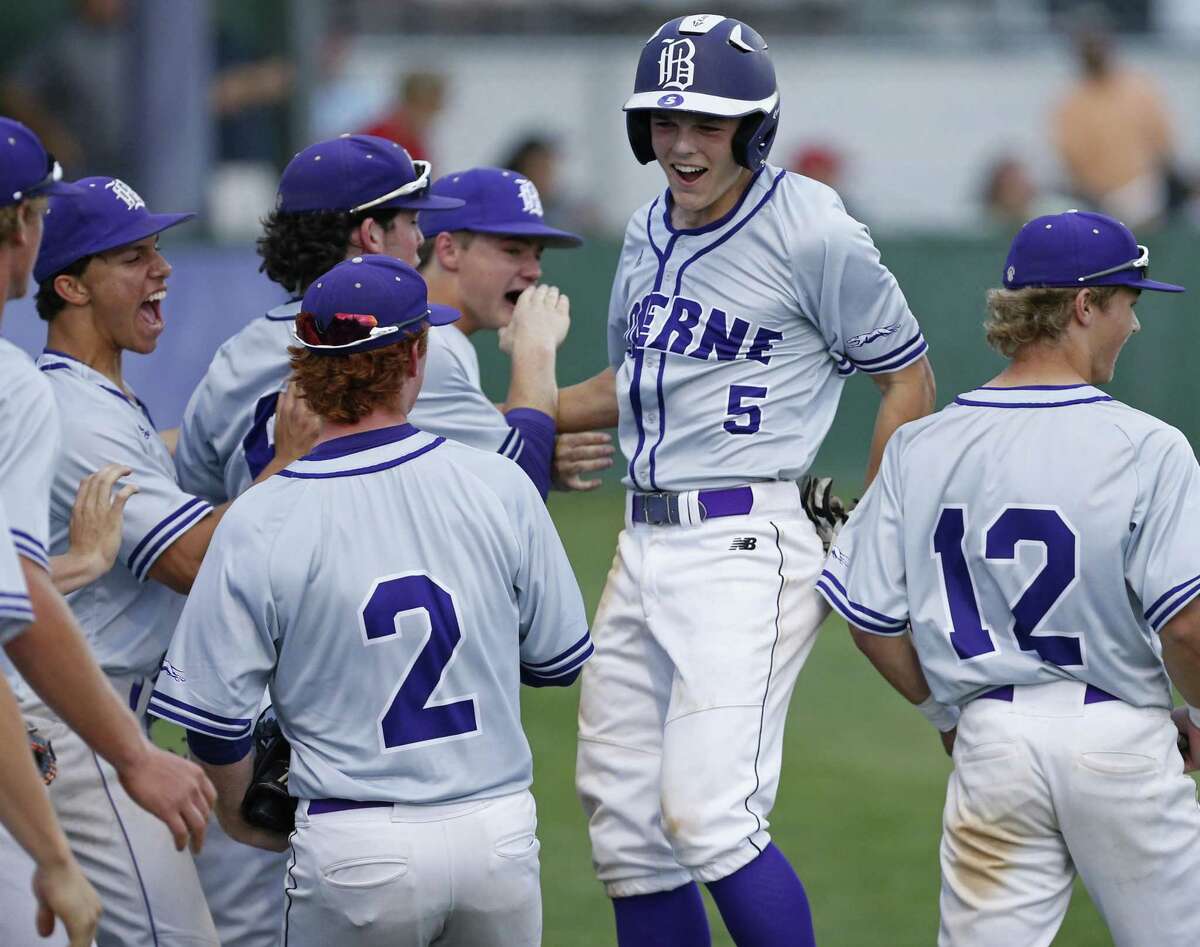 Boerne's Douglas Hodo (center) celebrates with teammates after scoring against Fredericksburg during the second inning Friday April 6, 2018 at Greyhound Field in Boerne, Tx.