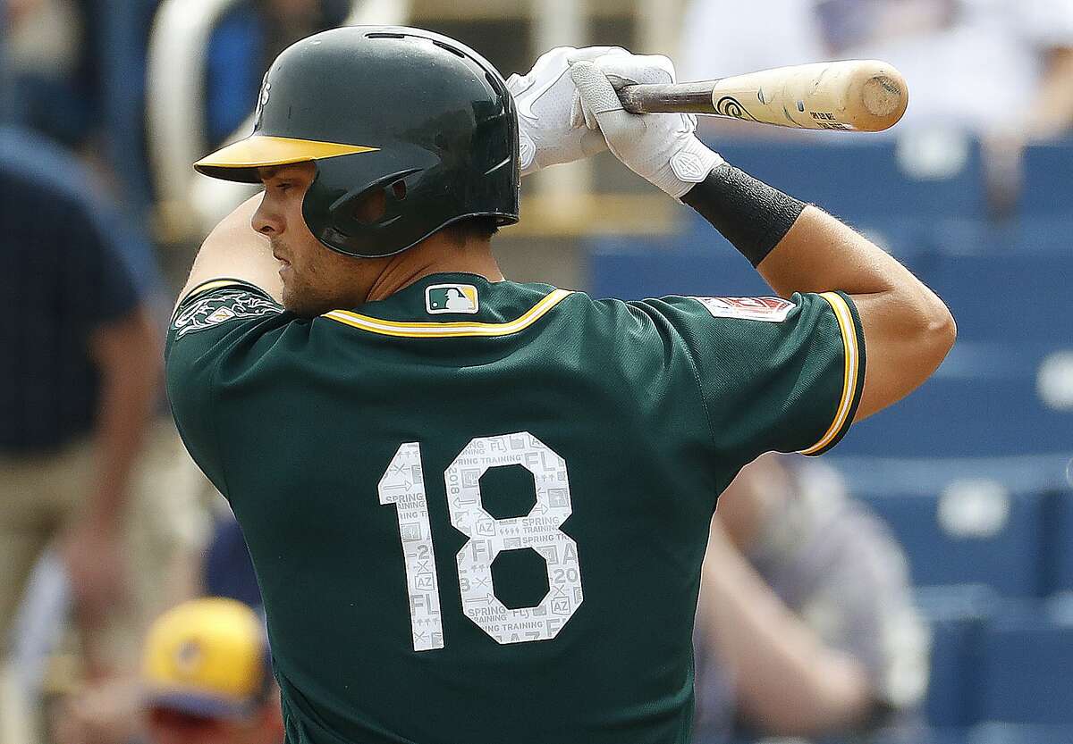 Athletics' Chad Pinder (18) hits against the Milwaukee Brewers during the first inning of a spring training baseball game Wednesday, March 21, 2018, in Phoenix.
