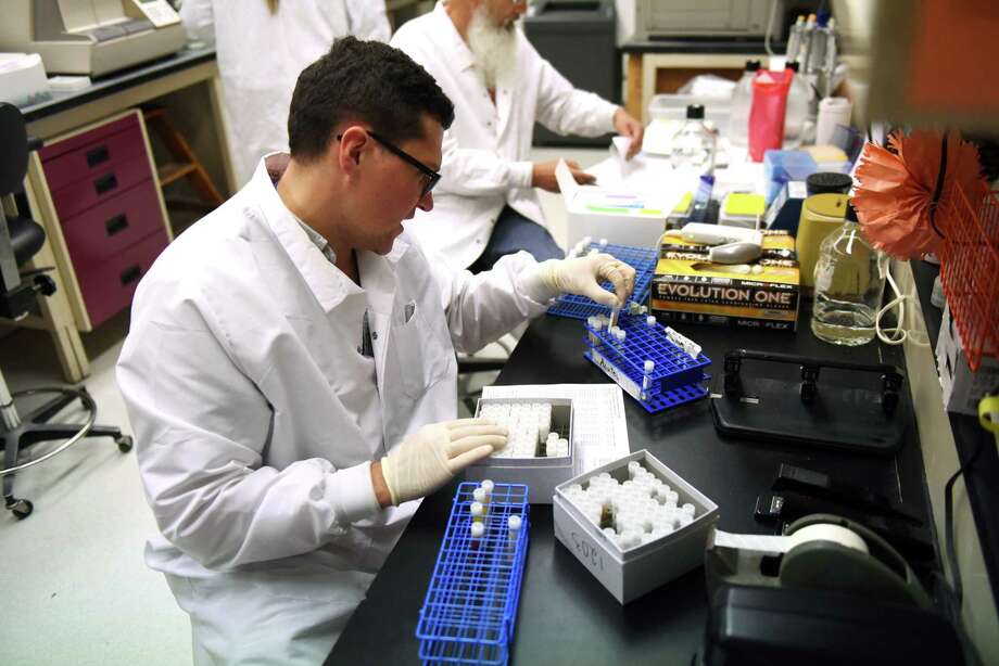 Kyle Carson, left, and Randy Stone, right, of Wadsworth Center, NYS Department of Health, select blood specimens to test for antibodies to arboviruses such as tickborne Powassan virus and mosquito borne Zika virus at a lab in the David Axelrod Institute on Tuesday, Aug. 8, 2017, in Albany, N.Y.   (Will Waldron/Times Union) Photo: Will Waldron / 20041235A