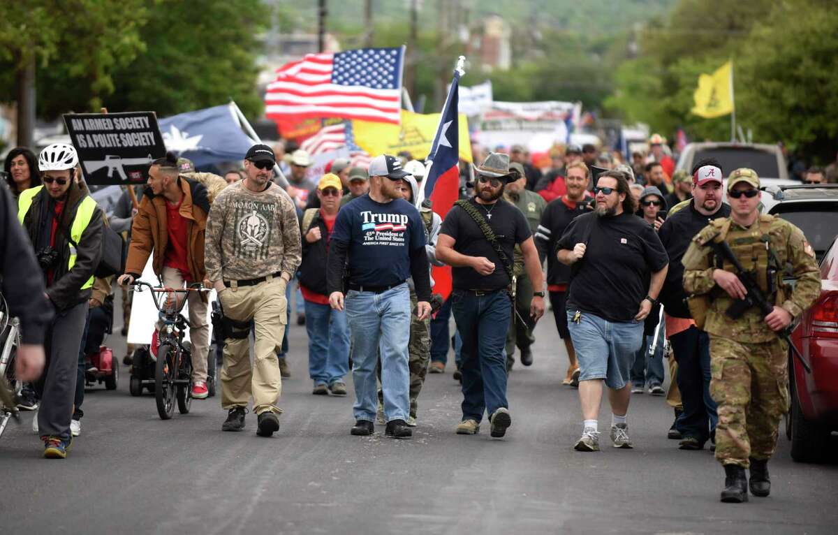 Members of Open Carry Texas and supporters stage a march in Olmos Park on Saturday, April 7, 2018. They were demanding that police chief Rene Valenciano lose his job over what they say is unfair treatment of their members.