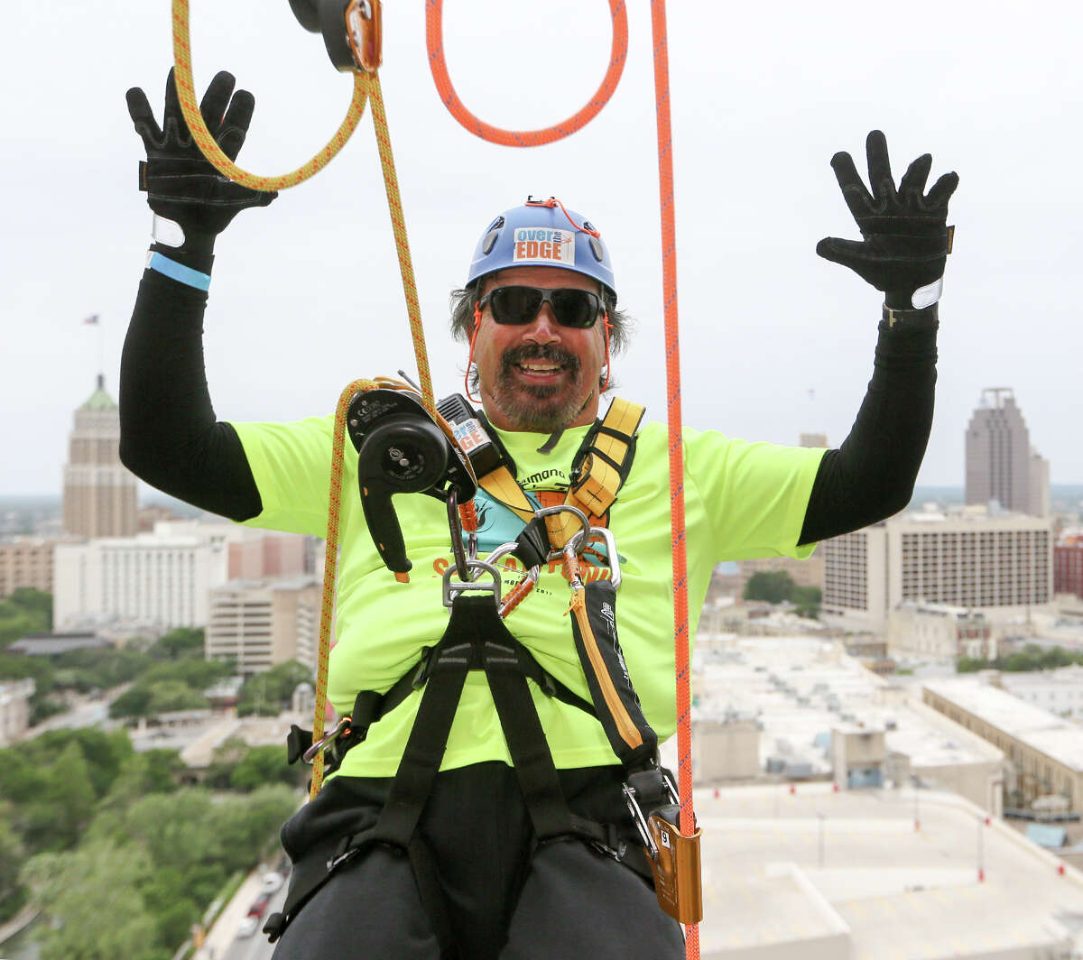 Rick Castillo goes "hands free" before rappeling from the 19th floor of the Marriott Rivercenter, 100 Bowie St. in Boysville, Inc.'s "Over the Edge" fundraising event on Saturday, April 7, 2018. MARVIN PFEIFFER/mpfeiffer@express-news.net