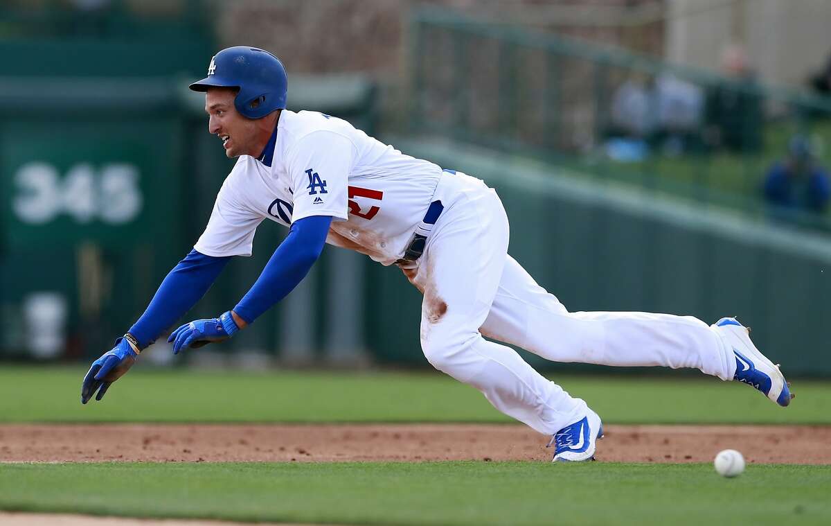 FILE - In this Feb. 23, 2018, file photo, Los Angeles Dodgers' Trayce Thompson steals second during the team's spring training baseball game against the Chicago White Sox in Glendale, Ariz.T he Dodgers have cut Thompson, the brother of Golden State Warriors star Klay Thompson. Thompson was competing for a spot in a crowded Los Angeles outfield that includes Chris Taylor, Yasiel Puig, Matt Kemp, Joc Pederson and Andrew Toles. Thompson was designated for assignment by the defending NL champions to make room on the 40-man roster for right-hander Cory Mazzoni, who was claimed off waivers from the Chicago Cubs. (AP Photo/Carlos Osorio, File)