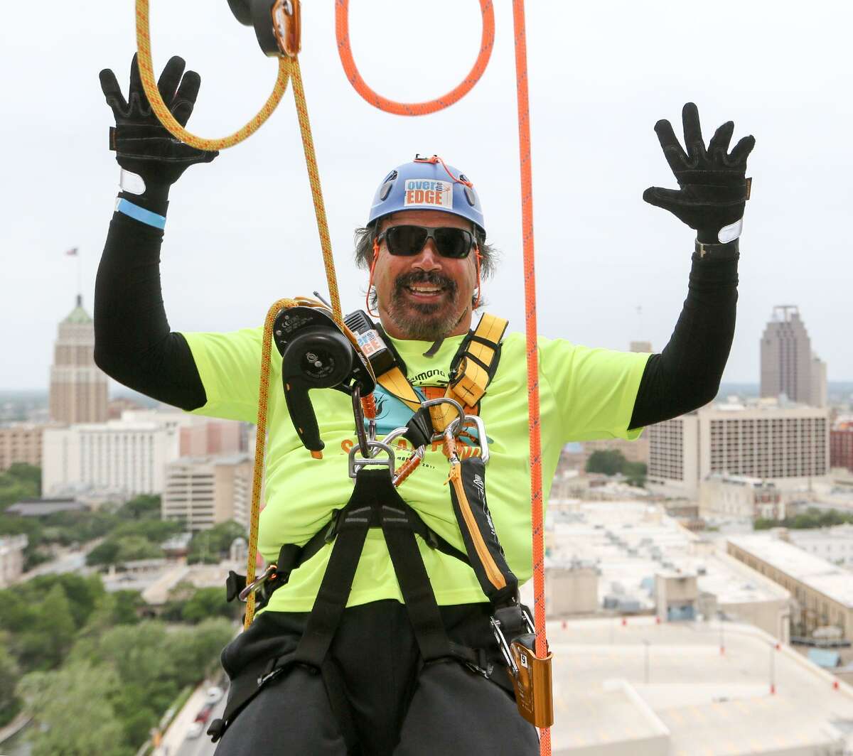 Rick Castillo goes "hands free" before rappelling from the 19th floor of the Marriott Rivercenter, 100 Bowie St. in Boysville's "Over the Edge" fundraising event on Saturday, April 7, 2018. MARVIN PFEIFFER/mpfeiffer@express-news.net