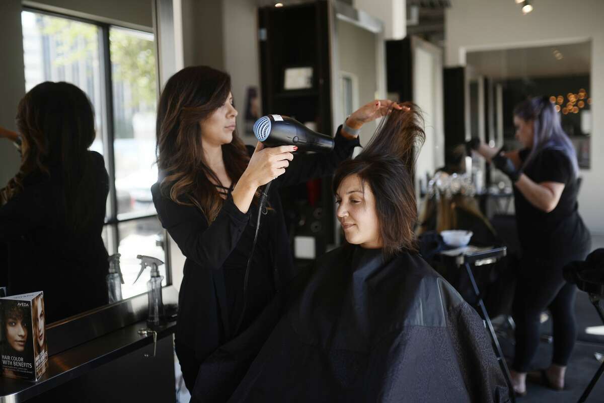 Chrissy Hale, owner of Halo Hair and Beauty Bar, works with Katie Jerath April 7, 2018. James Durbin/Reporter-Telegram