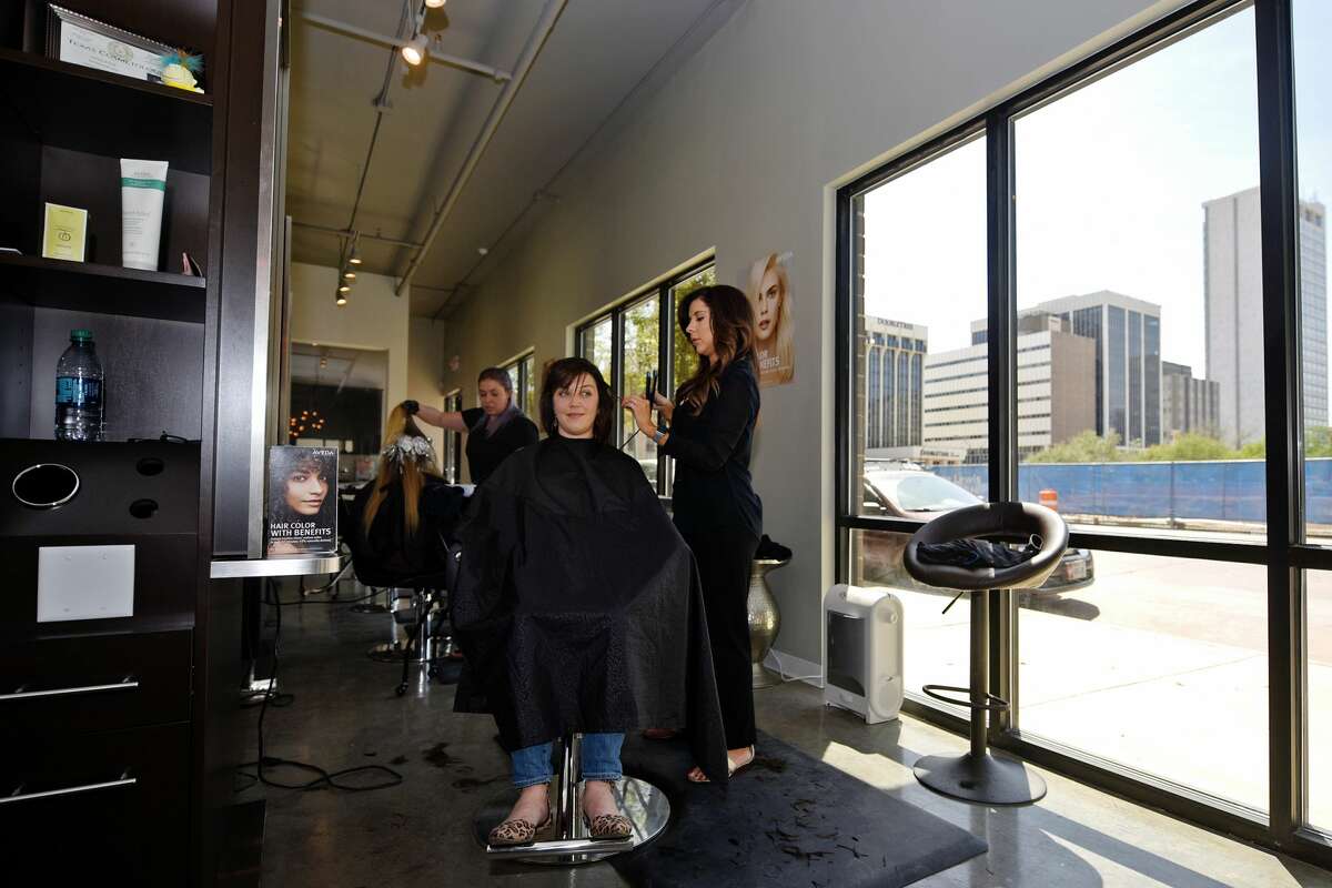 Chrissy Hale, owner of Halo Hair and Beauty Bar, works with Katie Jerath April 7, 2018. James Durbin/Reporter-Telegram