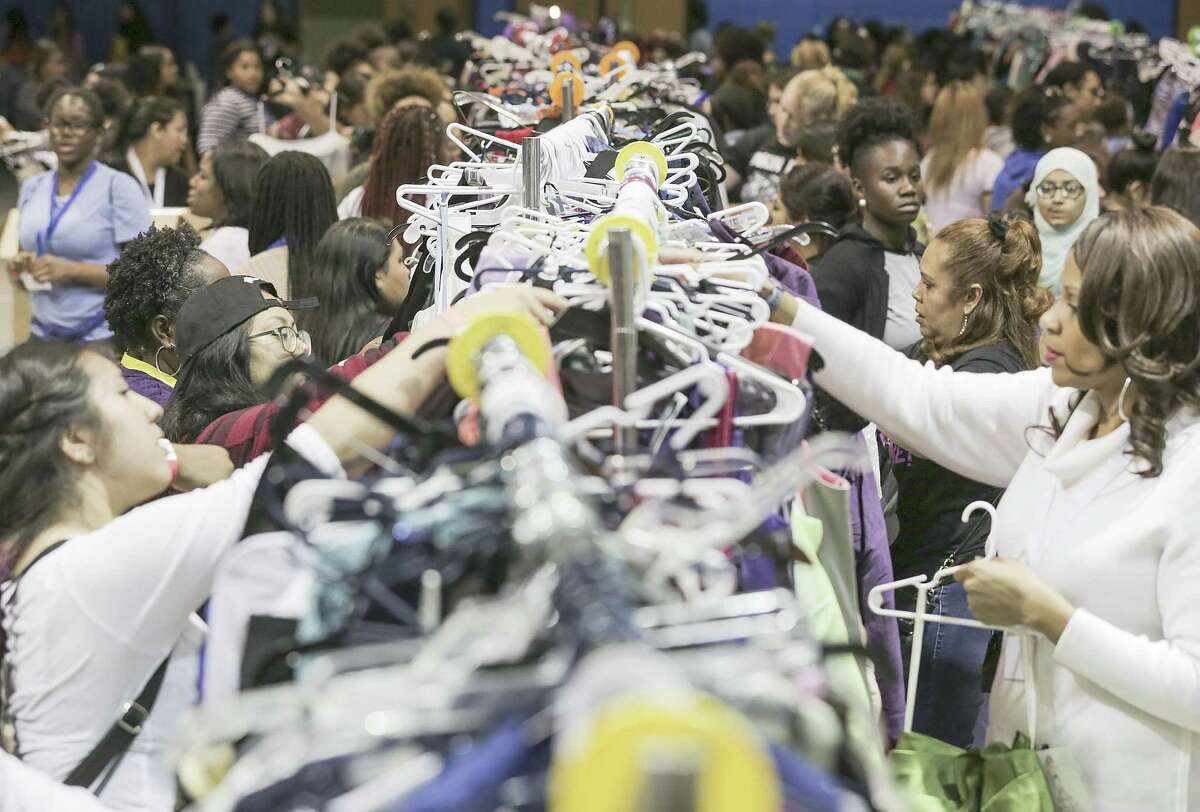 Hundreds of attendees check out the donated dresses during Project Prom distribution at Pin Oak Middle School on Saturday, April 7, 2018, in Bellaire. Over 900 HISD students were able to select prom attire at no cost during the event. ( Elizabeth Conley / Houston Chronicle )