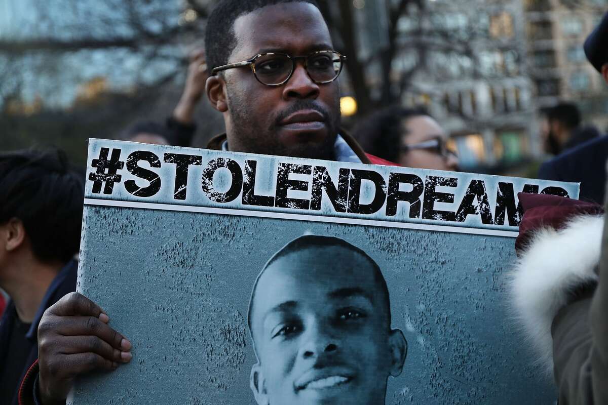 People attend a vigil for Stephon Clark, the young black man killed by police in Sacramento, on the anniversary of the assassination of Dr. Martin Luther King on April 4, 2018 in New York City. Tensions have flared in Sacramento and across the nation after an independent autopsy revealed that police officers shot Clark at least seven times in the back on March 18 while responding to reports of someone smashing car windows in his neighborhood. (Photo by Spencer Platt/Getty Images)