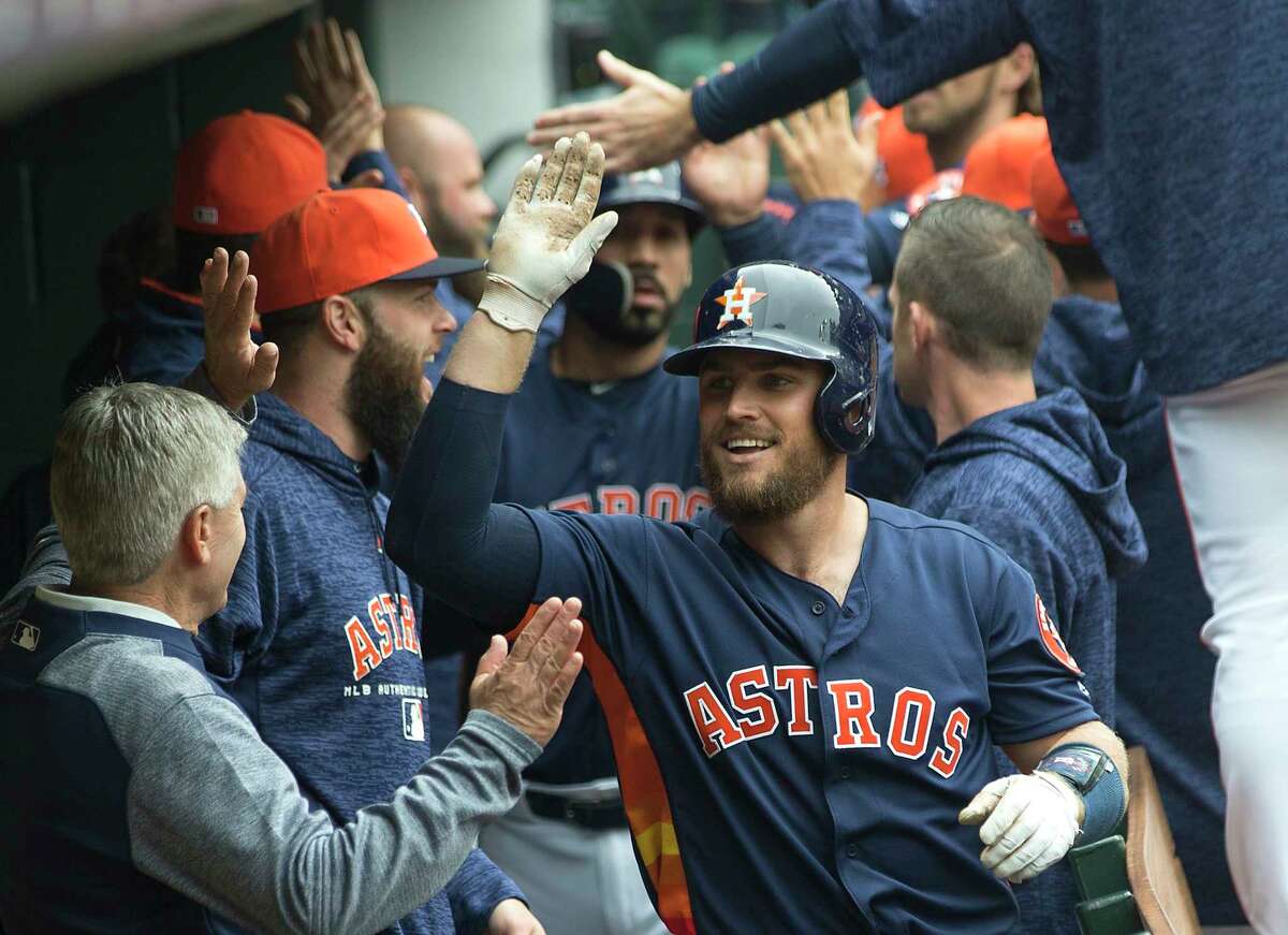 Houston Astros catcher Max Stassi (12) high fives his teammates in the dugout after hitting a 3-run home run off of San Diego Padres starting pitcher Tyson Ross during the fifth inning of a major league baseball game at Minute Maid Park on Sunday, April 8, 2018, in Houston.