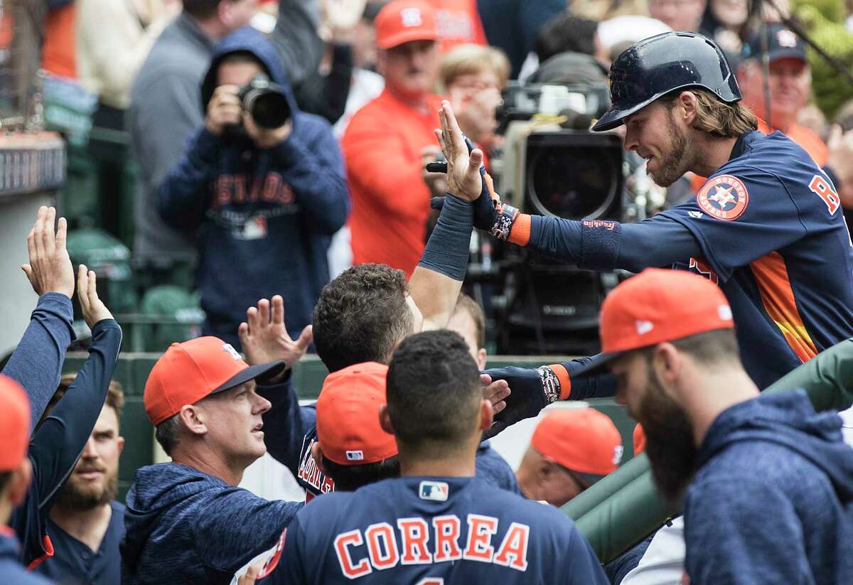 Houston Astros right fielder Josh Reddick (22) high fives his teammates as he reaches the dugout after hitting a solo home run off San Diego Padres starting pitcher Tyson Ross during the sixth inning of a major league baseball game at Minute Maid Park on Sunday, April 8, 2018, in Houston.