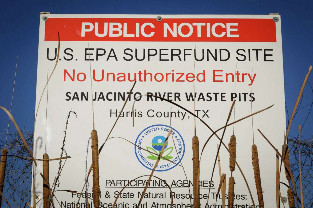 A sign warns the public about the EPA Superfund Site not to eat contaminated seafood caught from the water along I-10 near the San Jacinto River east of Houston, Tuesday, Dec. 17, 2013, in Channelview. Texans Together, the Harris County Attorney's Office and residents are working together to spotlight the public health, fishing, and financial disaster that will result if a hurricane hits the San Jacinto Waste Pits, a highly vulnerable, toxic waste superfund site in the middle of the San Jacinto River and flows into Galveston Bay. A recent government report reveals that the plastic lining placed in 2011 over the site's toxic wastes-- which the Waste Management and International Paper promised would protect the public for years, is eroding. ( Michael Paulsen / Houston Chronicle )