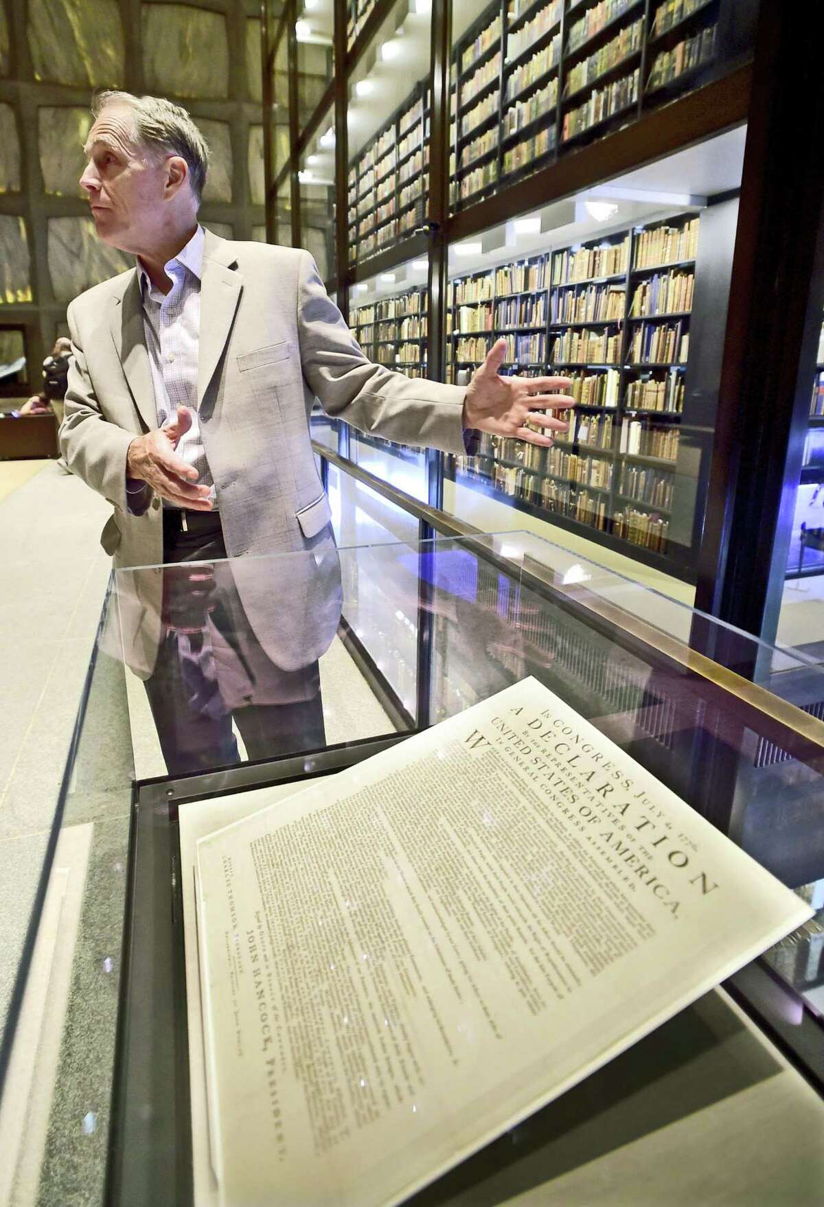 (Peter Hvizdak / Hearst Connecticut Media) New Haven, Connecticut: June 28, 2017. George Miles, the William Robertson Coe Curator of Yale Collections of Western Americana at the Beinecke Rare Book & Manuscript Library at Yale University in New Haven with a first printed issue of the Declaration of Independence by John Dunlap in Philadelphia on July 4, 1776 at the library.
