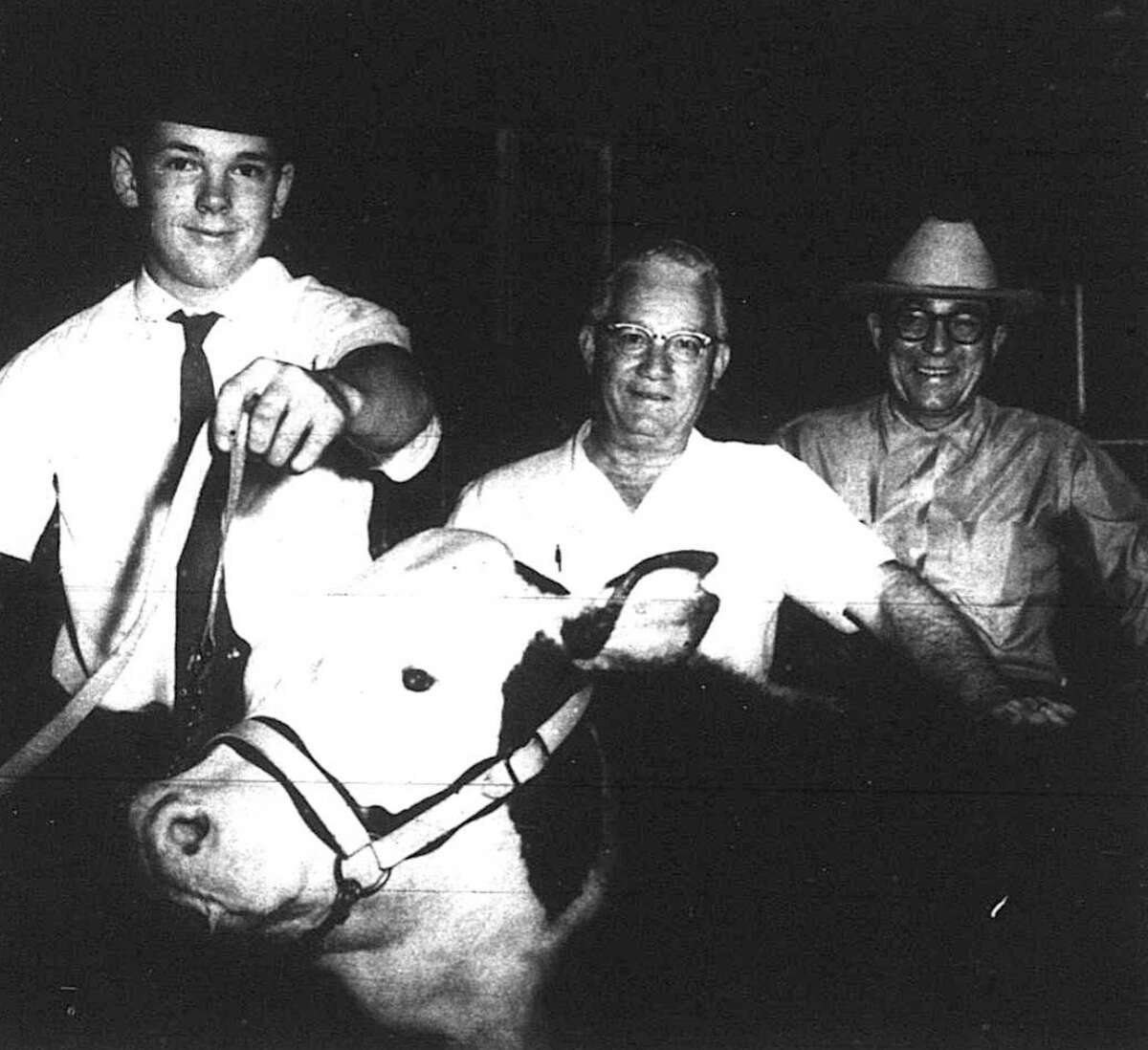 Pictured are R. D. Simonton and Frank Powell representing the Conroe National Bank, with "Jake" the Grand Champion Steer of the 1965 Junior Livestock Show at Cow Palace. He was shown by Martin Weldon of Willis FFA. The steer brought in a record over the previous year.