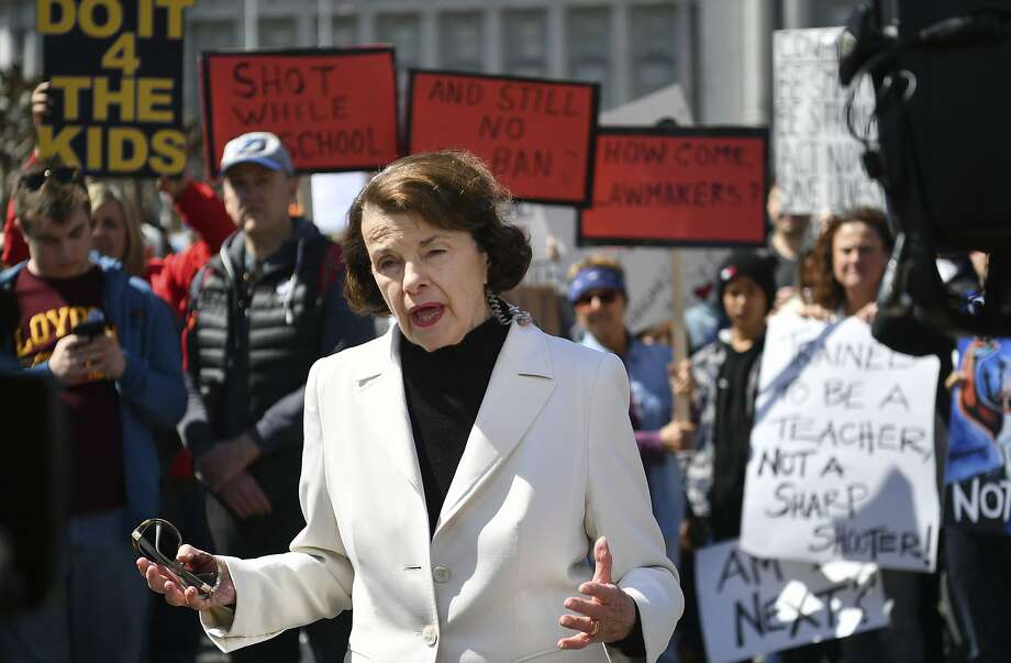 Sen. Dianne Feinstein, D-Calif., speaks to members of the media as crowds of people participate in the "March for Our Lives" rally in support of gun control, Saturday, March 24, 2018, in San Francisco. In a historic groundswell of youth activism, hundreds of thousands of teenagers and their supporters rallied across the U.S. against gun violence Saturday, vowing to transform fear and grief into a "vote-them-out" movement and tougher laws against weapons and ammunition. (AP Photo/Josh Edelson) Photo: Josh Edelson / Associated Press