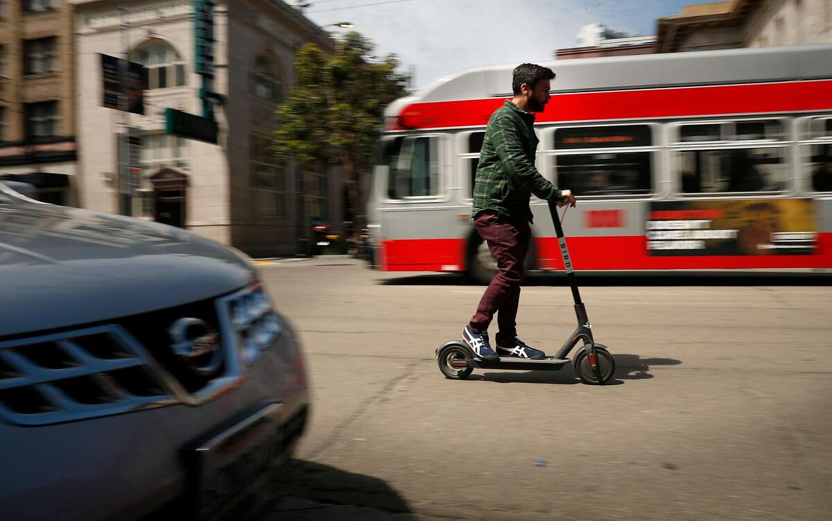 Cruising down Mission st. on a Bird scooter as seen on Mon. April 9, 2018, in San Francisco, Calif.