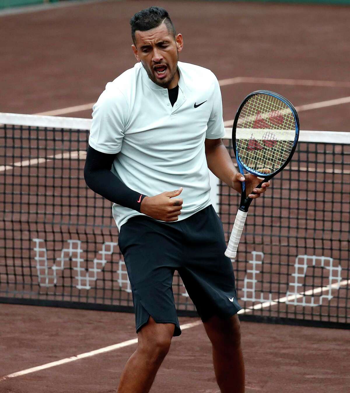 Nick Kyrgios reacts in the first round of doubles with Matt Reid during the U.S. Men's Clay Court Championship at River Oaks Country Club, Monday, April 9, 2018, in Houston.