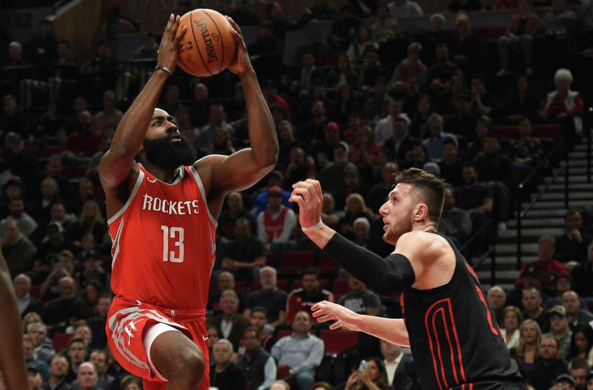 Houston Rockets guard James Harden drives to the basket on Portland Trail Blazers center Jusuf Nurkic during the first half of an NBA basketball game in Portland, Ore., Tuesday, March 20, 2018. (AP Photo/Steve Dykes)