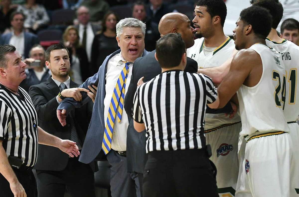 Referees and coaches try to hold back head coaches Jimmy Patsos of Siena, center, and Kevin Baggett of Rider, right of center, during a fight that broke out during a basketball game at the Times Union Center on Tuesday, Jan. 17, 2017, in Albany, N.Y. (Lori Van Buren/Times Union archive)