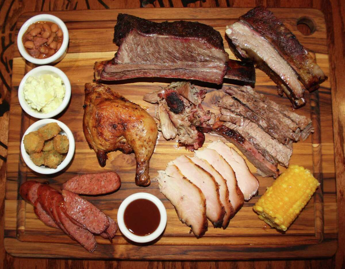The board at Choke Canyon Bar-B Que includes (clockwise from top left) barbecue beans, beef ribs, pork ribs, brisket, corn, turkey, pulled pork, chicken, sausage, fried okra and Cajun potato salad.
