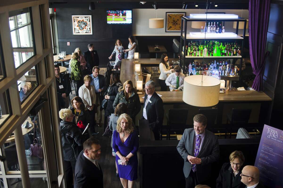 Community members get their first look inside Gratzi, the new Italian restaurant which is located at 120 E. Main Street on the lower level of The H Residence, during a ribbon cutting event hosted by the Midland Area Chamber of Commerce on Tuesday, April 10, 2018. (Katy Kildee/kkildee@mdn.net)