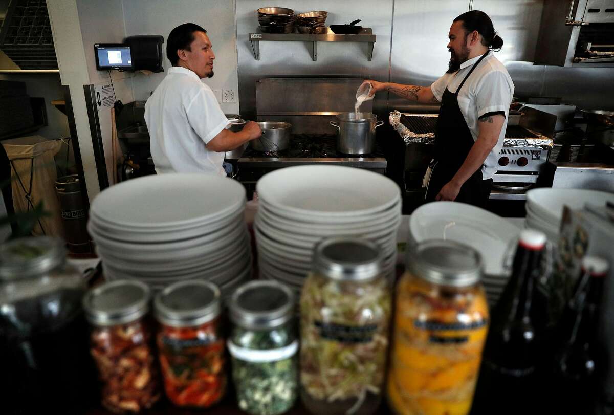Filemon Vazquez, left, and Sous Chef Brock Crandall, right, getting things ready during dinner prep time at Son's Addition restaurant in San Francisco, Calif., on Tuesday, April 10, 2018. The restaurant industry is feeling new tensions surrounding ICE raids and inspections, as workers who might be undocumented are nervous of being caught in immigration sweeps.