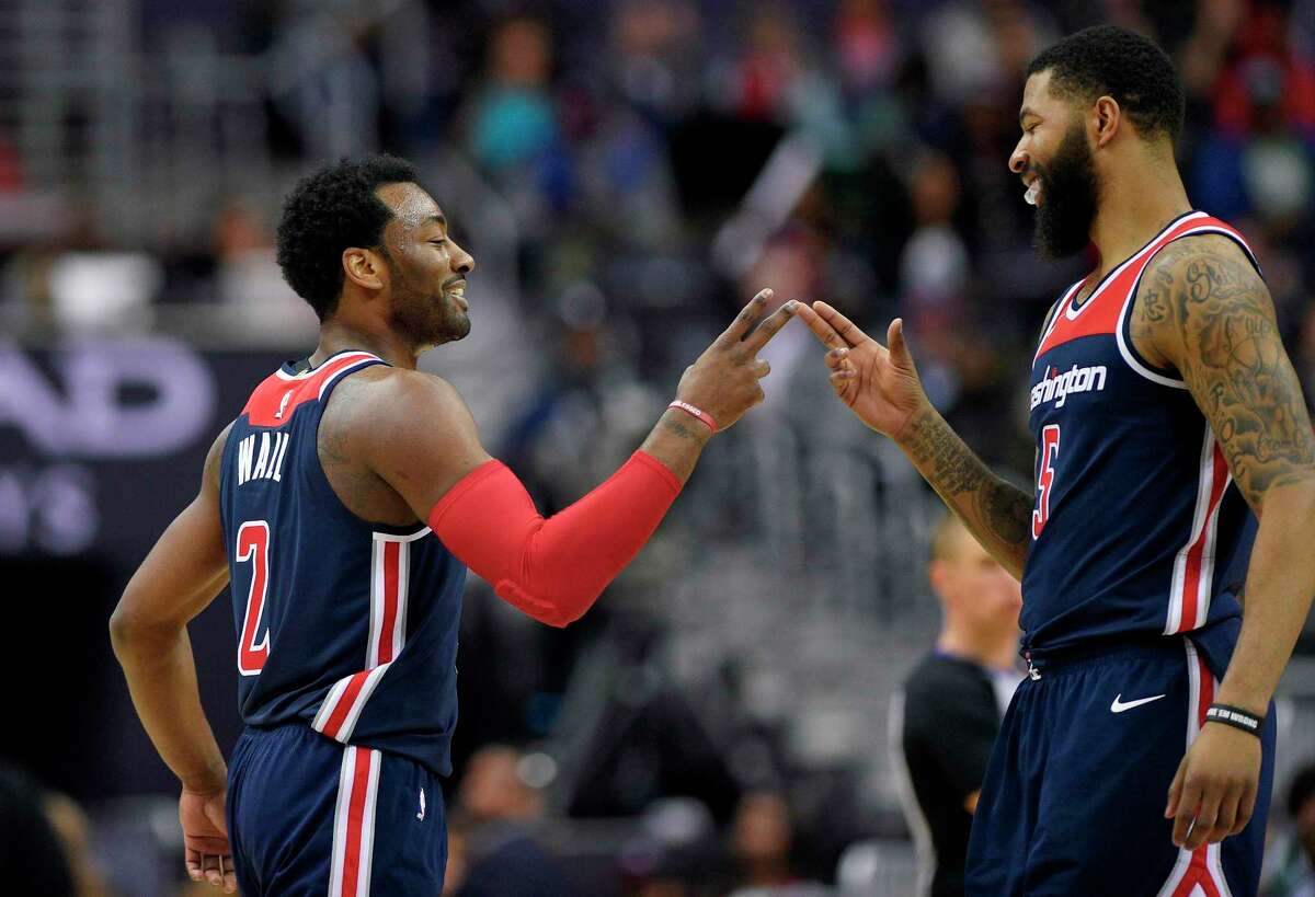 Washington Wizards guard John Wall (2) reacts with forward Markieff Morris (5) during the second half of the tea's NBA basketball game against the Boston Celtics, Tuesday, April 10, 2018, in Washington. The Wizards won 113-101. (AP Photo/Nick Wass)