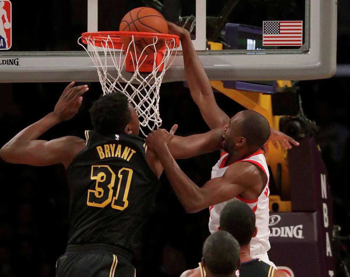 Houston Rockets forward Luc Mbah a Moute dunks the ball against Los Angeles Lakers center Thomas Bryant in the second quarter on Tuesday, April 10, 2018, at Staples Center in Los Angeles, Calif.