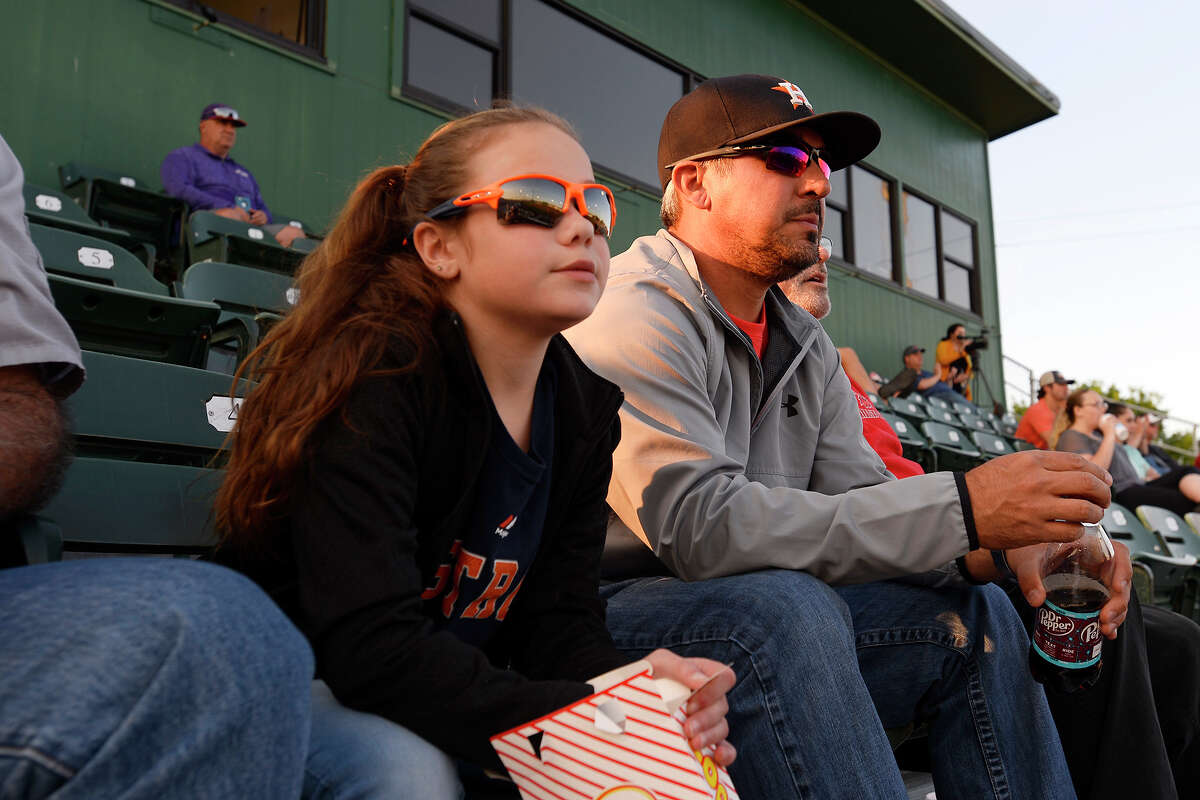 Patrick and Avery Owen, 9, wear Houston Astros attire to watch as the Lamar Cardinals baseball team takes on Northwestern State at Vincent-Beck Stadium. Photo taken Tuesday 4/10/18 Ryan Pelham/The Enterprise