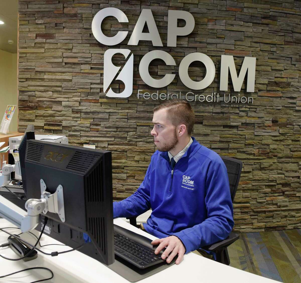 Ryan Dare, a Regional Member Relationship Officer, works in the main branch at CapCom Headquarters on Tuesday, March 13, 2018, in Colonie, N.Y. (Paul Buckowski/Times Union)