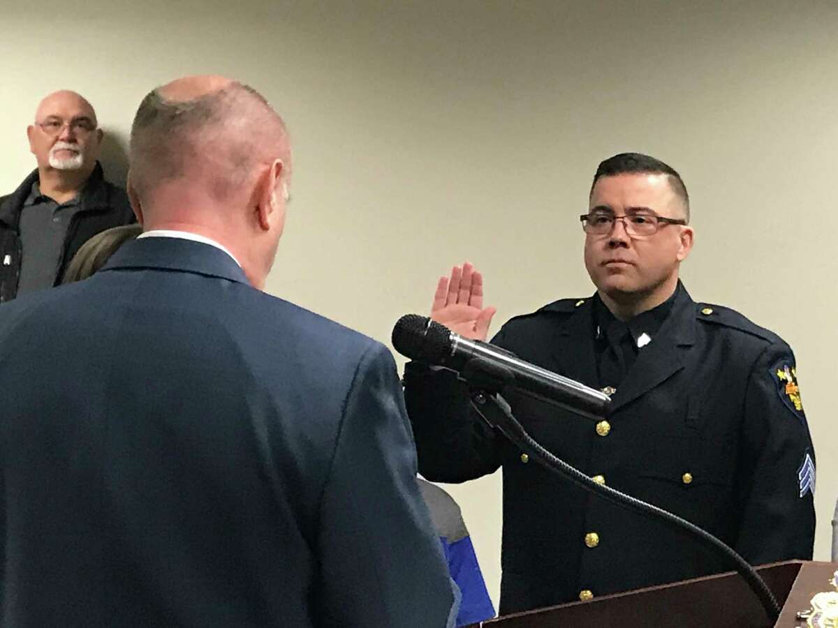 Troy Police Sgt. John Becker is sworn in Wednesday as the department's newest captain.