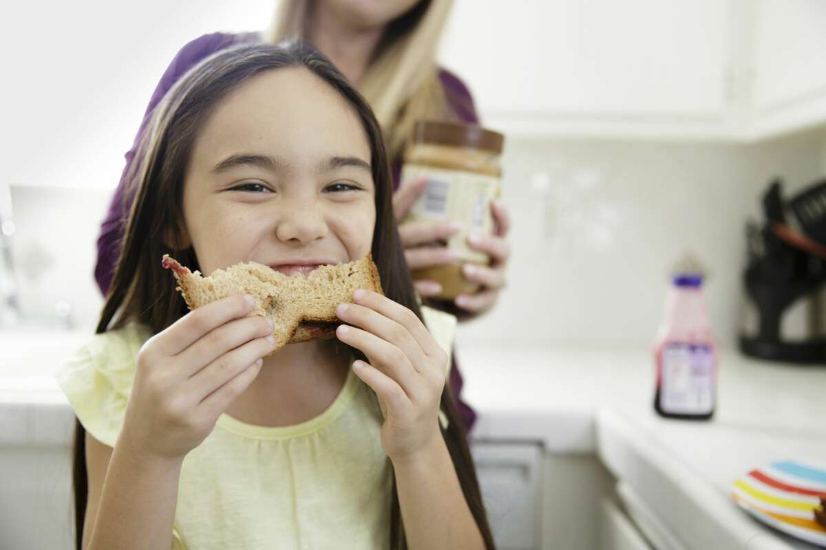 PHOTOS: 8 things you didn't know about peanut butter This stock image girl wisely eats her peanut butter and jelly sandwich at home instead of in a shopping cart at Target.